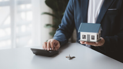 The salesperson of the housing estate in the project is preparing and verifying the contract of...