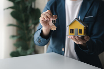 The salesperson of the housing estate in the project is preparing and verifying the contract of...