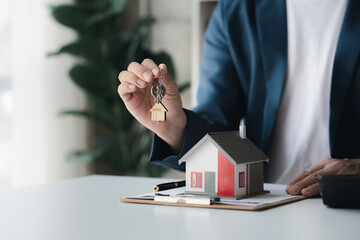 The salesperson of the housing estate in the project is preparing and verifying the contract of...