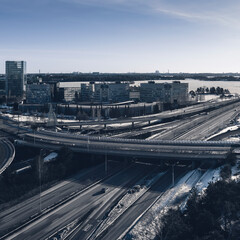 Aerial view of a freeway intersection Snow-covered in winter.Busy intersection. Birds eye view from drone. Cityscape