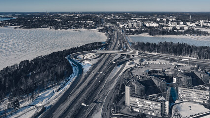 Aerial view of a freeway intersection Snow-covered in winter.Busy intersection. Birds eye view from drone. Cityscape