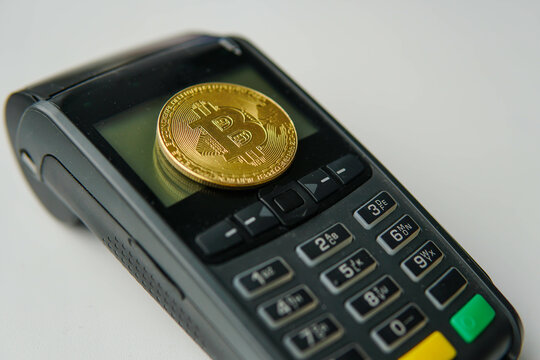Golden bitcoin btc with POS payment terminal. Cryptocurrency for payment.
