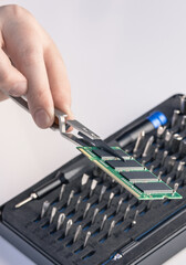 Technician fixing computer. Repair and upgrade concept of laptop. Workshop background