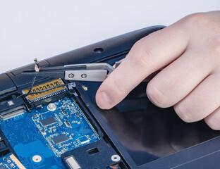 Technician fixing computer. Repair and upgrade concept of laptop. Workshop background