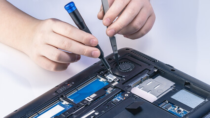 Technician fixing computer. Repair and upgrade concept of laptop. Workshop background