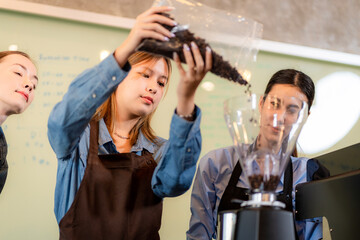 The coffee shop lady is preparing the equipment for the opening of the shop to serve coffee drinks to customers with standard service, cleanliness and international taste.
