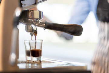 The coffee shop lady is preparing the equipment for the opening of the shop to serve coffee drinks to customers with standard service, cleanliness and international taste.