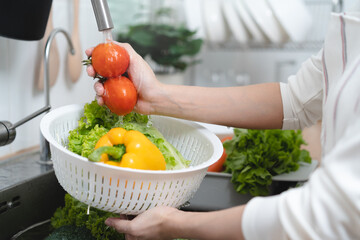 people washing raw vegetables at sink in the kitchen prepare ingredient for cooking
