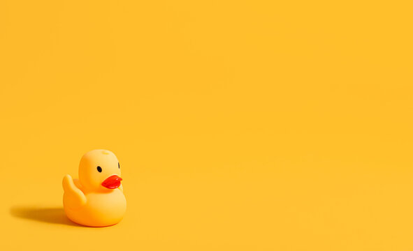 Rubber duck for swimming on a yellow background. Children's toy. Banner. Copy space.