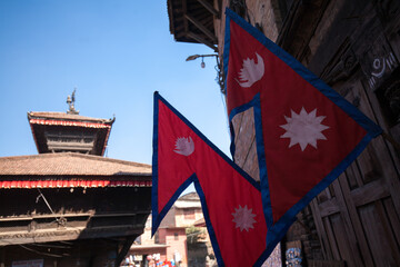 Nepal flag in Bhaktapur Durbar Square, Nepal - obrazy, fototapety, plakaty