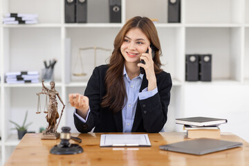 female business woman lawyers working and call phone at the law firms. Judge gavel with scales of justice. Legal law, lawyer, documents, advice and justice concept.