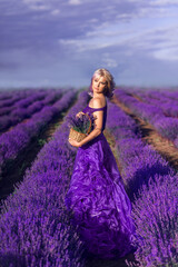 beautiful woman in a long purple dress and a large hat in lavender. A girl with a basket of flowers...