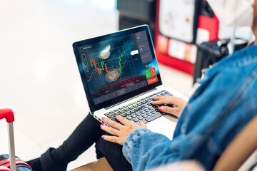 Fototapeta premium Successful of business trader investor woman use technology laptop trading graph of block chain stock market cryptocurrency investment selling and buy with price chart data graph