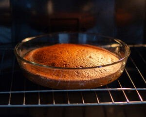 Hot ruddy cake in a home oven. Cooked pie in a glass pan. Homemade baking. Delicious food and dessert. Healthy eating