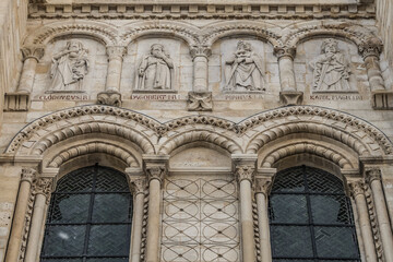 Fototapeta na wymiar Fragments of the facade of Basilica of Saint-Denis (Basilique royale de Saint-Denis, from 1144) - former medieval abbey church in city of Saint-Denis, a northern suburb of Paris. France.