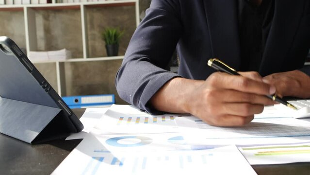 Business people working with documents in the office analyzing financial documents and accounting figures.