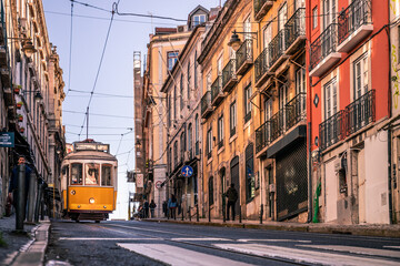 Plakat The legendary Tram 28 in the old town of Bairro Alto. Old house fronts and narrow streetsLisbon, Portugal