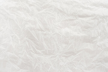Texture of crumpled white paper. Background of light paper with bends and scuffs