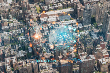 Aerial top view of New York City building roofs. Bird's eye view from helicopter of metropolis cityscape. Decentralized economy. Blockchain, cryptography and cryptocurrency concept, hologram
