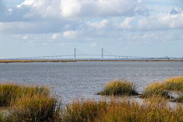 bridge over a river and cloudy sky