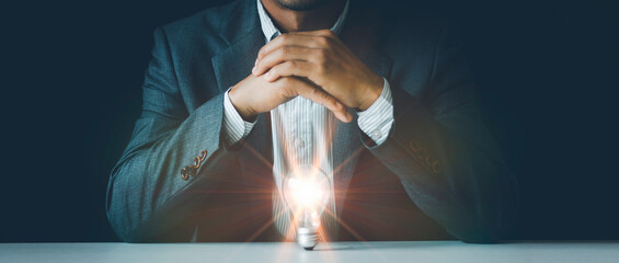 Light blub under hands, businessman protects the light bulb, Creative new idea, brainstorming,...