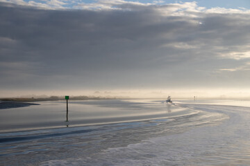 Boat on a river on a misty morning