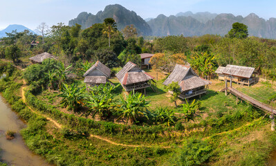 Fototapeta na wymiar Traditional old house built with wood and has a beautiful mountain view in Vang Vieng, LAO.