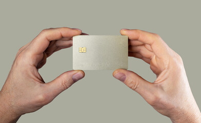 Bank card mockup, sample in men hands closeup. Blank debit credit bankcard with chip of gold color