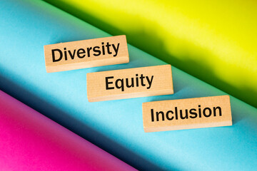 Diversity, equality, inclusion, DEI symbol, Written on wooden blocks, Colored background, Business...