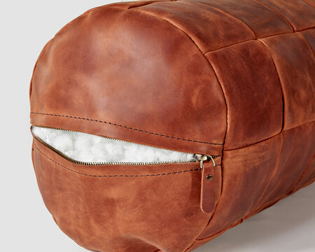 Copper-colored leather bolster pillow with zipper and holofiber filling