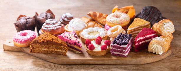 Sweet dessert. Various piece of cakes, muffins, donuts and cookies