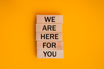 we are here for you, Written on wooden blocks, words to live by, Business idea. invitation to...