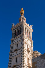 Obraz premium Marseille, France - FEB 28, 2022: Basilica of Notre-Dame de la Garde or la Bonne Mere in Marseille, France