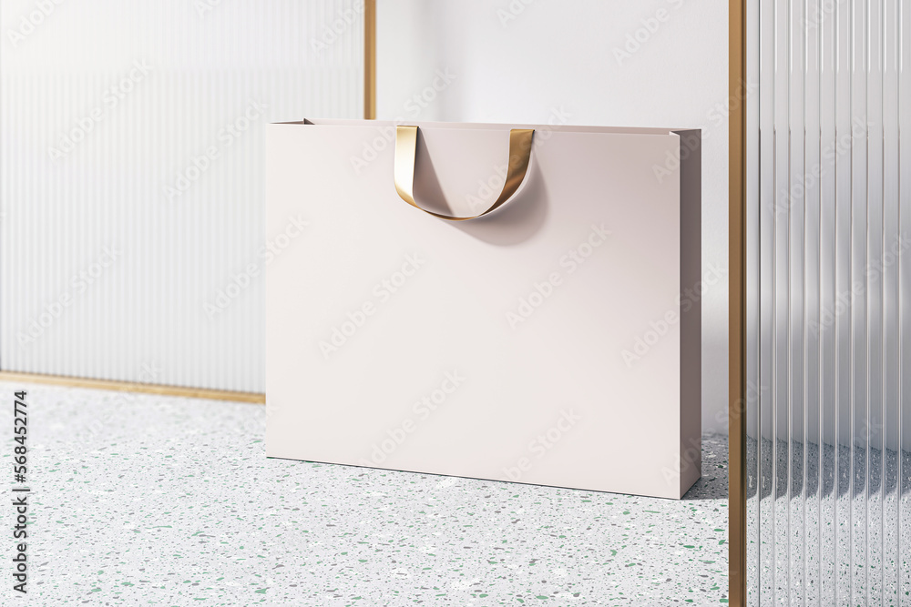 Poster perspective view on blank beige paper shopping bag with golden braid and place for your brand name o