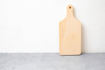 Wooden chopping board on gray cement table top