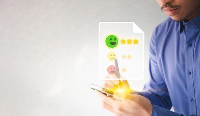 Business quality feedback concept. Man doing online satisfaction review on satisfaction service by using smartphone with virtual interface. 
