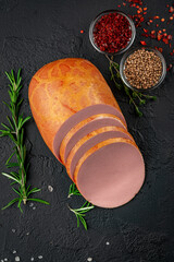 Stick of boiled sausage on a dark background.Doctor's sausage isolated on a white background.