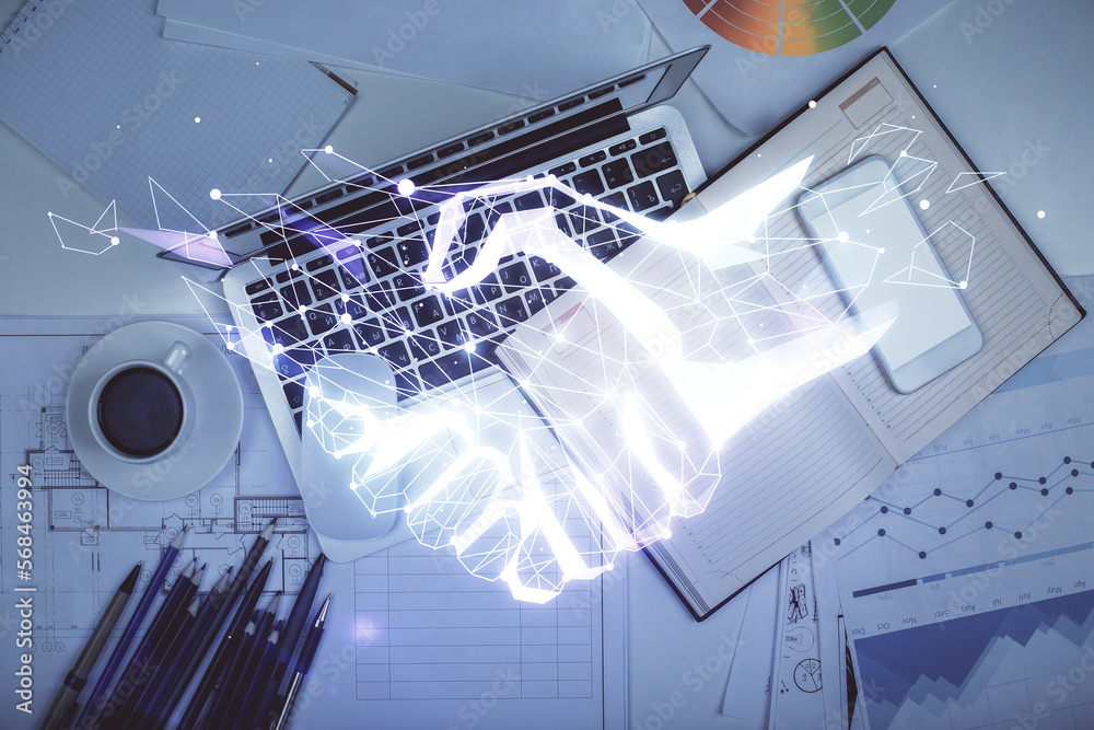 Poster handshake drawing over computer on the desktop background. top view. double exposure. partnership co