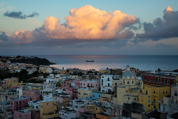 Beautiful fishing village in sunset, Marina Corricella on Procida Island, Bay of Naples, Italy.