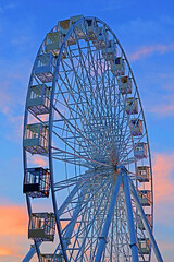 The Ferris wheel in the historical part of Kyiv on the Kontraktova Square on Podol in the evening, Kyiv, Ukraine
