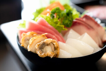 Japanese sashimi sushi set serve on ice with warm light at japanese restaurant.