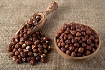 View of a bowl full of hazelnuts on burlap sack
