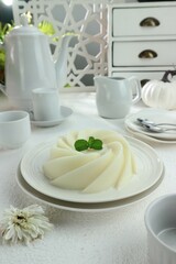 white pudding topped with mint leaves