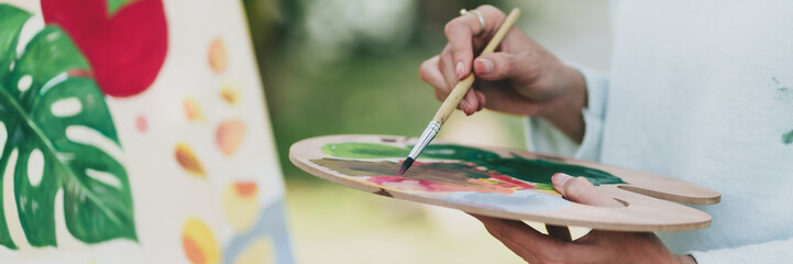 Female artist painting art canvas&nbsp;drawing&nbsp;with inspiration in garden art therapy creativity concept