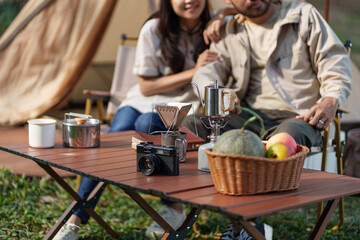 Asian couple camping outdoors. Couple travelers holding hands together love and Travel Lifestyle.