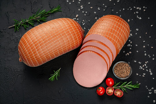 Stick of boiled sausage on a dark background.Doctor's sausage isolated on a white background.