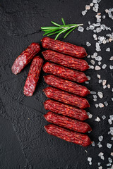 Smoked sausages of the highest quality.. On a black background.