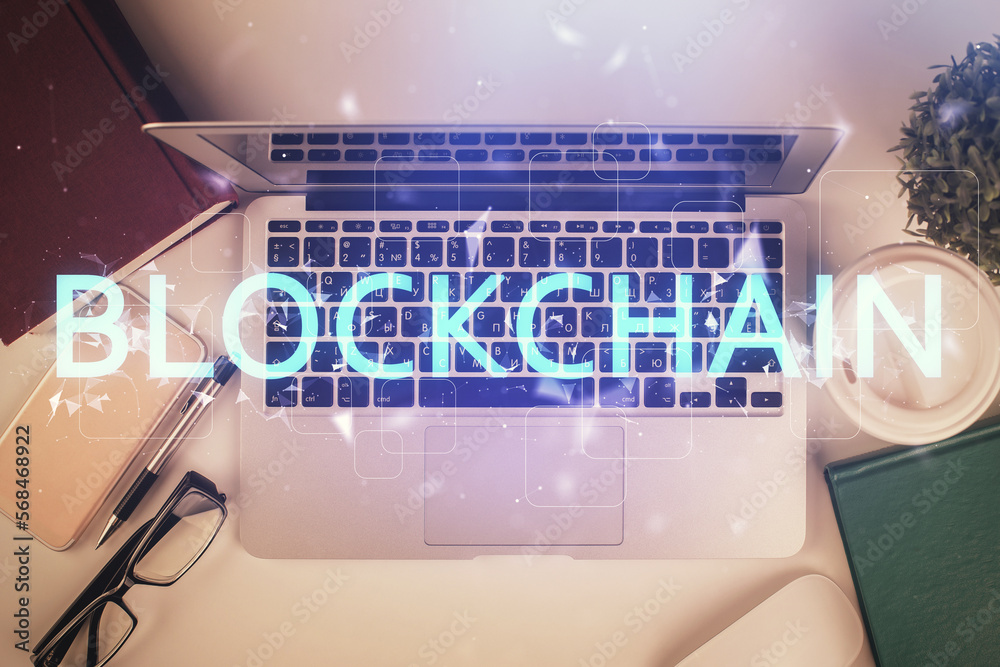 Poster Blockchain theme hologram drawings over computer on the desktop background. Top view. Double exposure.