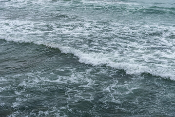 Storm sea. Waves on the sea dispersed by the wind on a cloudy day.