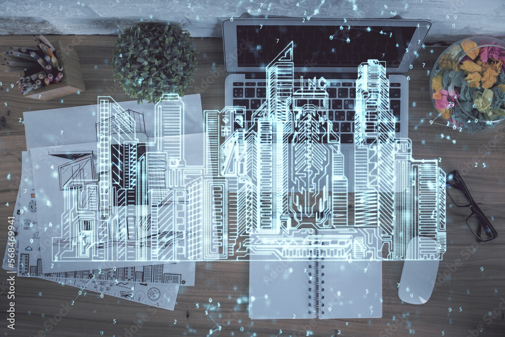 Poster city drawing over computer on the desktop background. top view. double exposure. smart home concept.